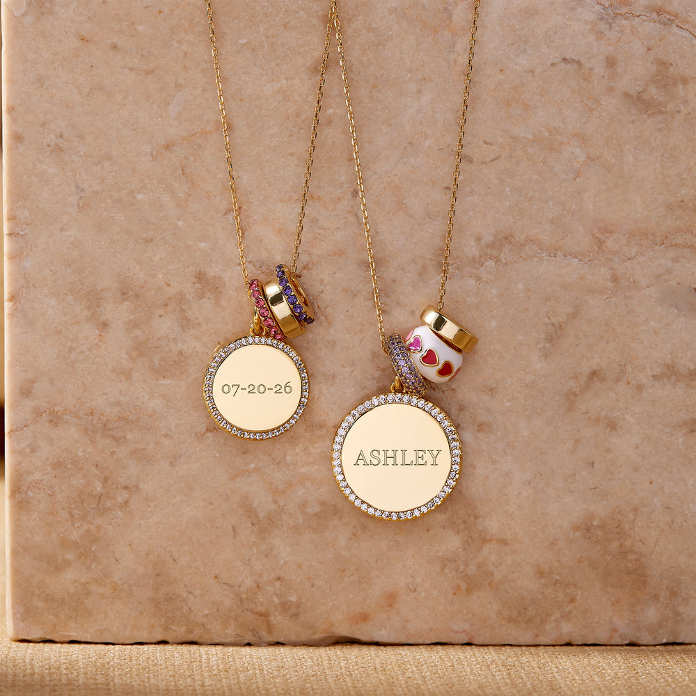  Two Anniversary Charm Necklaces on a chain, each with a pavé-edged round engraved disc pendant and stacked bead charms, one with colorful crystal rings, one with an enamel heart bead.