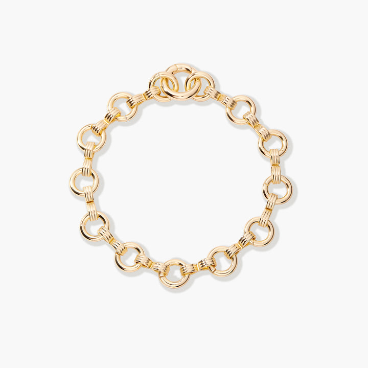 Gold-tone Merritt Bracelet with large round links connected by ridged rectangular connectors and an interlocking ring clasp.