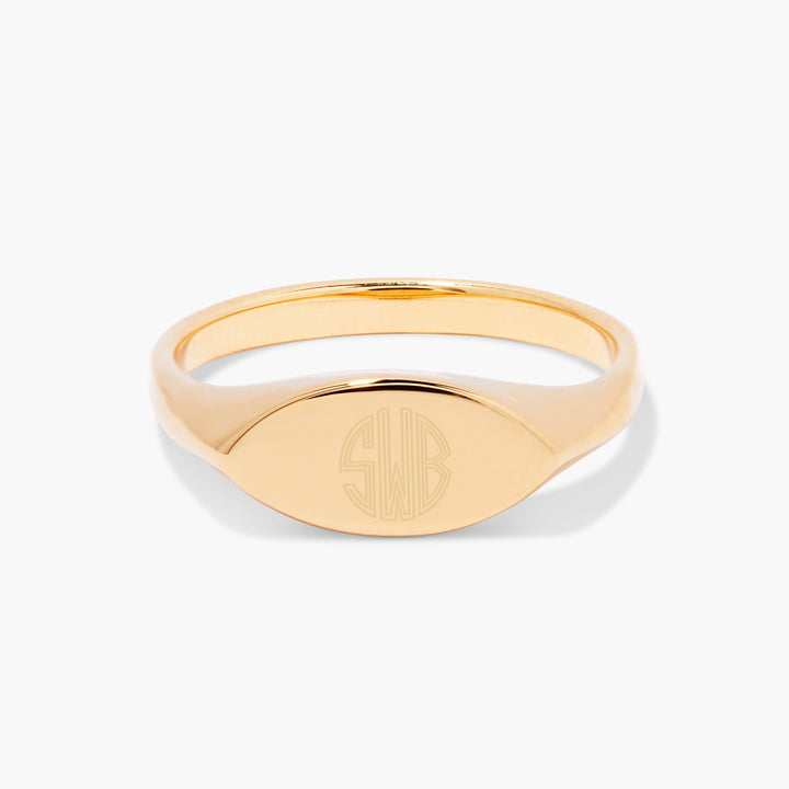 Evelyn Signet Ring with an oval face engraved with three block-letter monogram initials, seen from the front.
