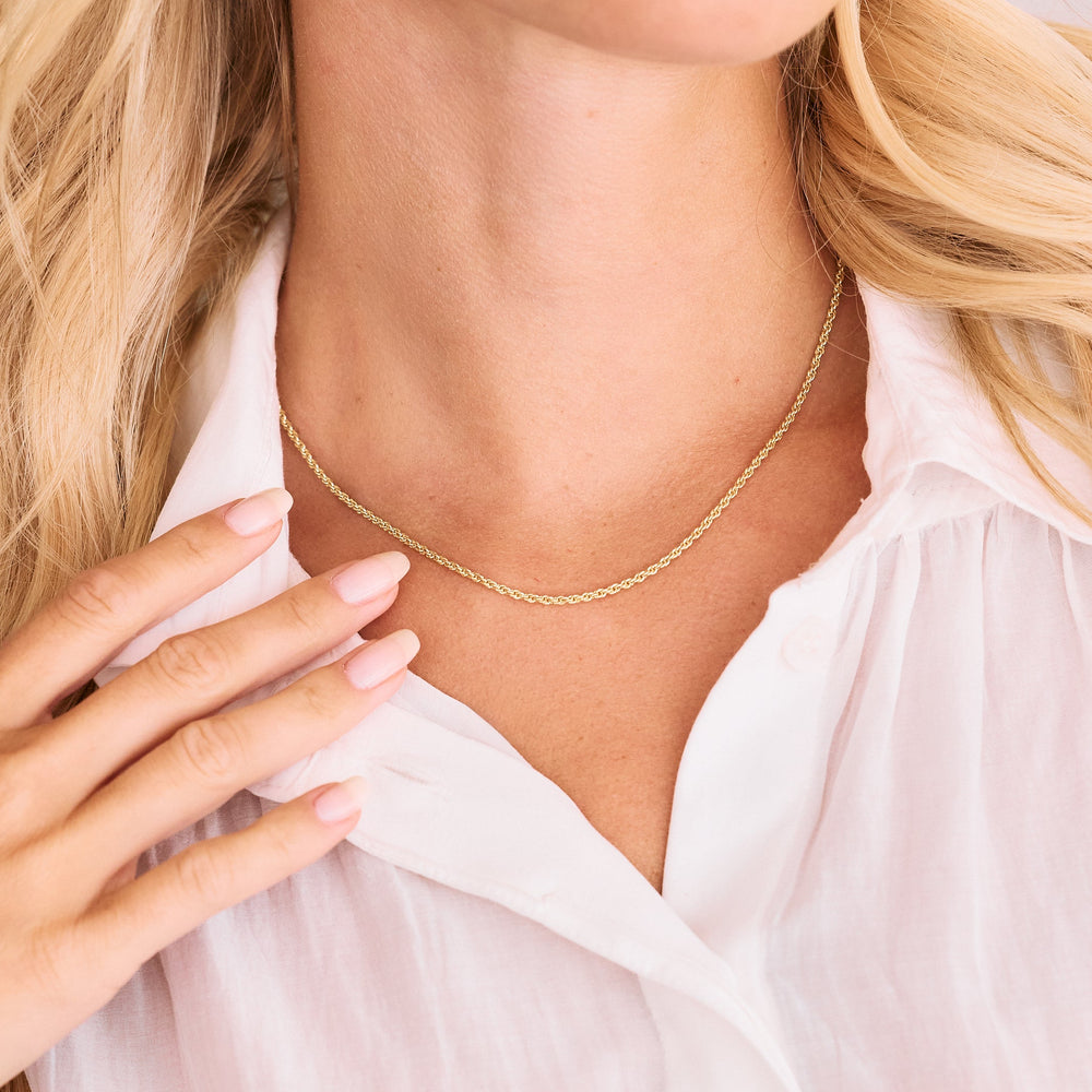  Thin twisted chain necklace worn by a model, sitting at choker length with a delicate rope-style texture.