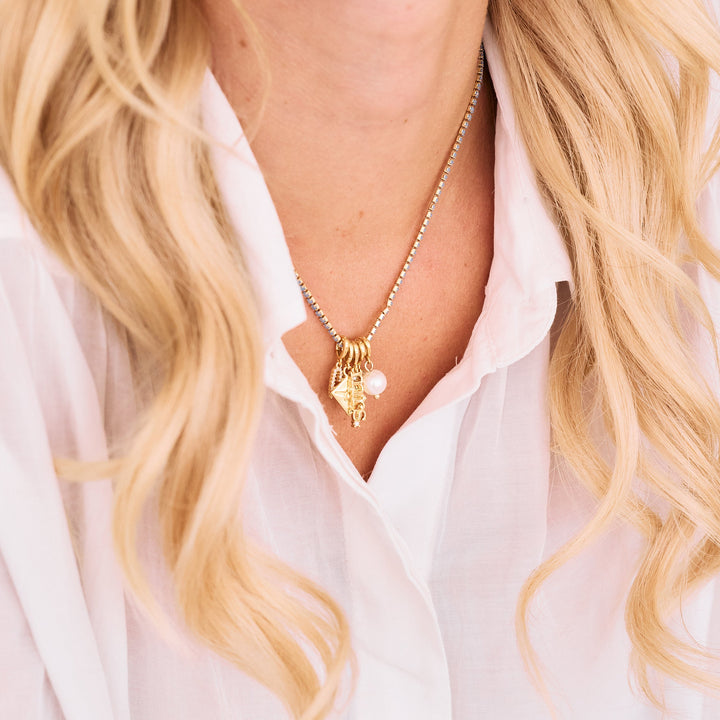 blue opal tennis necklace, with bridal charms hanging.